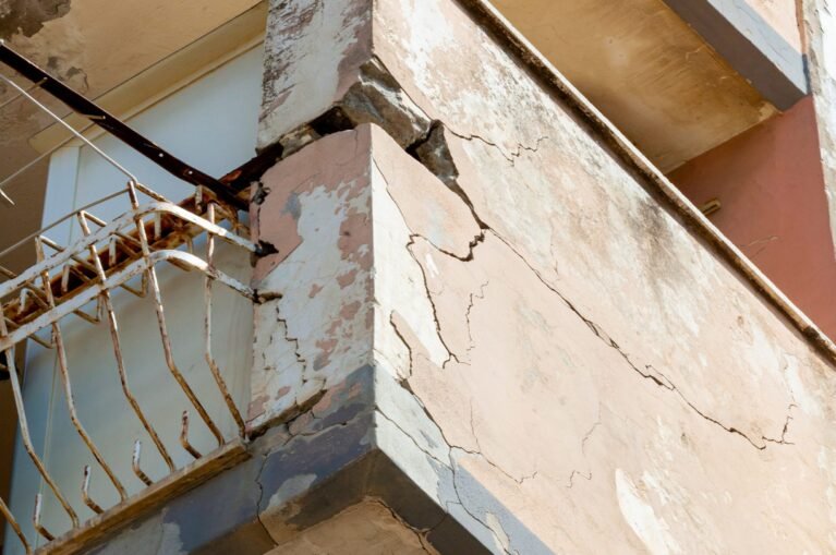Balconies with cracked concrete and rusty irons requiring renovation.