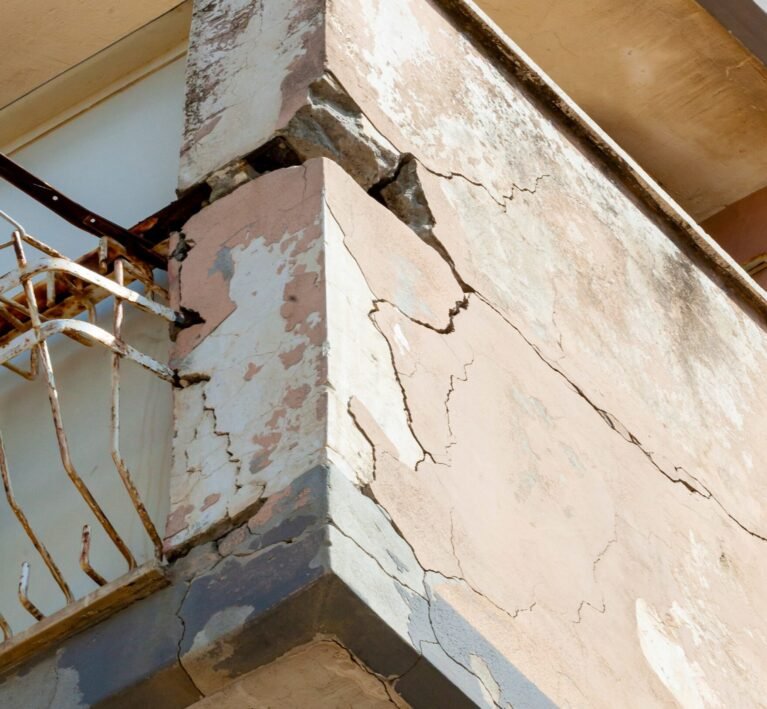 Balconies with cracked concrete and rusty irons requiring renovation.